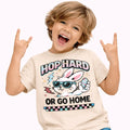 Hop Hard or Go Home Kids Easter T-Shirt- neutral featuring a cool bunny graphic and playful design on a child.
