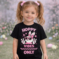 Hoppy vibes only Personalised T shirt pink worn by a girl with pigtails in a playful outdoor setting.
