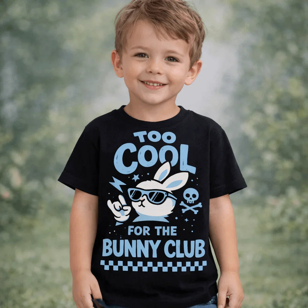 Too Cool for the Bunny Club Kids T-Shirt- blue worn by a smiling boy featuring a bunny graphic and vibrant colors.