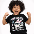 Hop Hard or Go Home Kids Easter T-Shirt featuring a happy child in a black tee with a sunglasses-wearing bunny design.