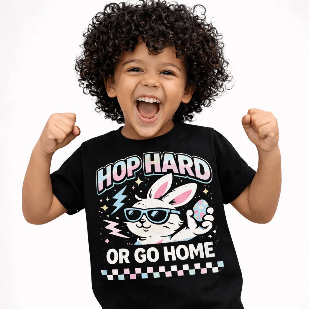 Hop Hard or Go Home Kids Easter T-Shirt featuring a happy child in a black tee with a sunglasses-wearing bunny design.