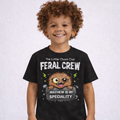 Boy wearing black FERAL CREW kids graphic t-shirt by The Little Chaos Club featuring cute feral monster design and bold white text