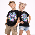 Black kids graphic t-shirt featuring colourful pastel soda pop art design worn by boy and girl model on white background
